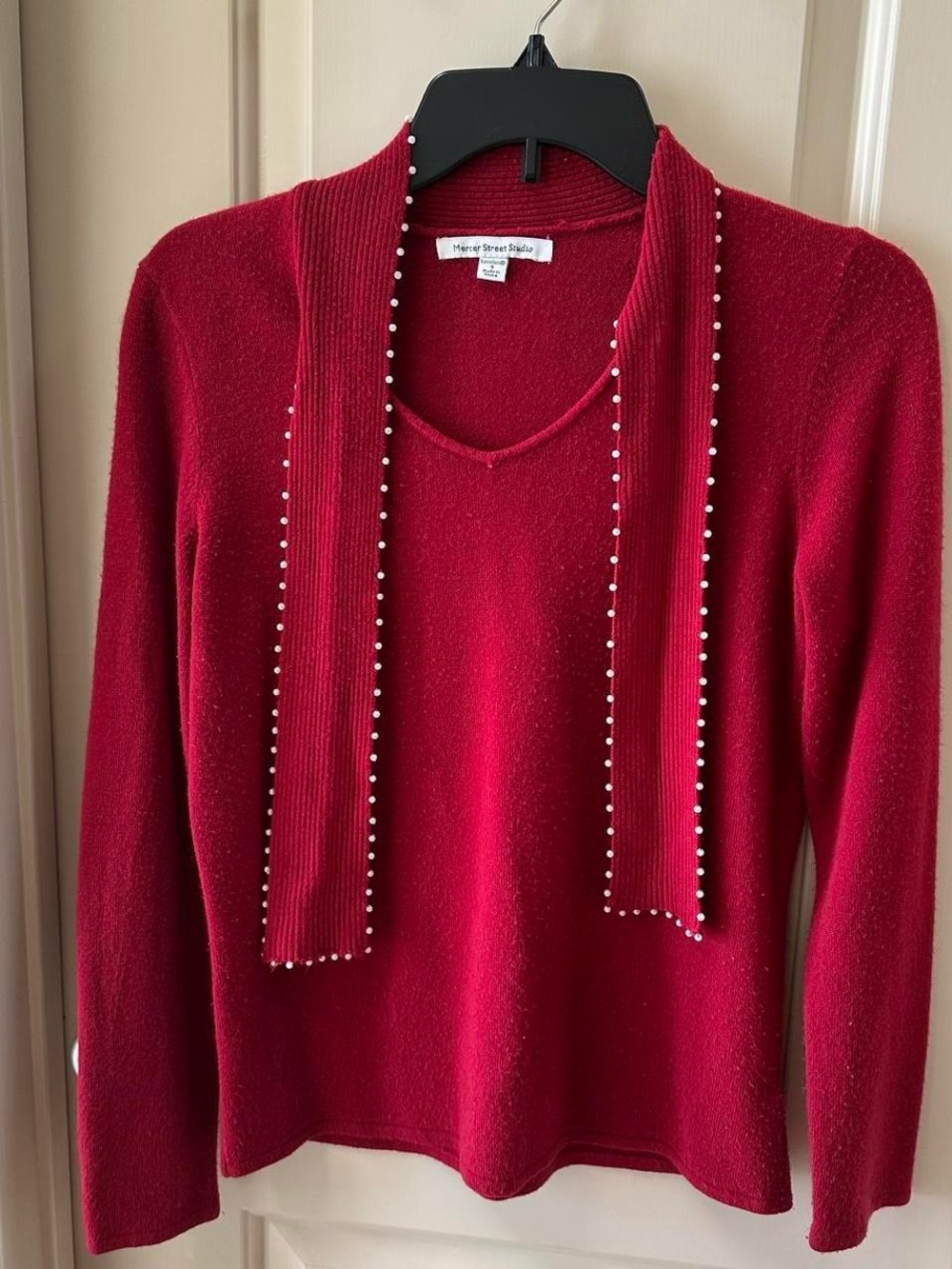 Chic red V-neck sweater with an attached scarf featuring pearl-like bead trim.